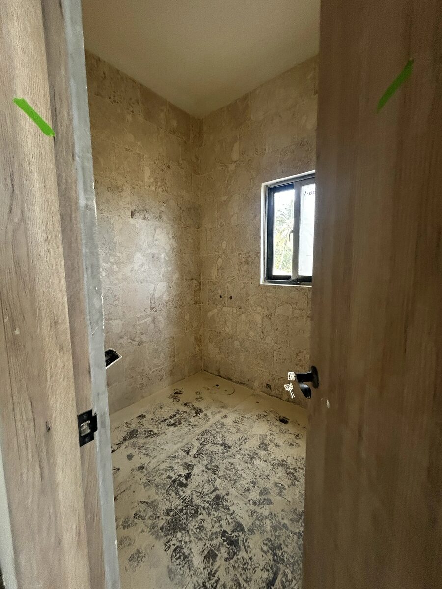 A plastered interior room with a window opening