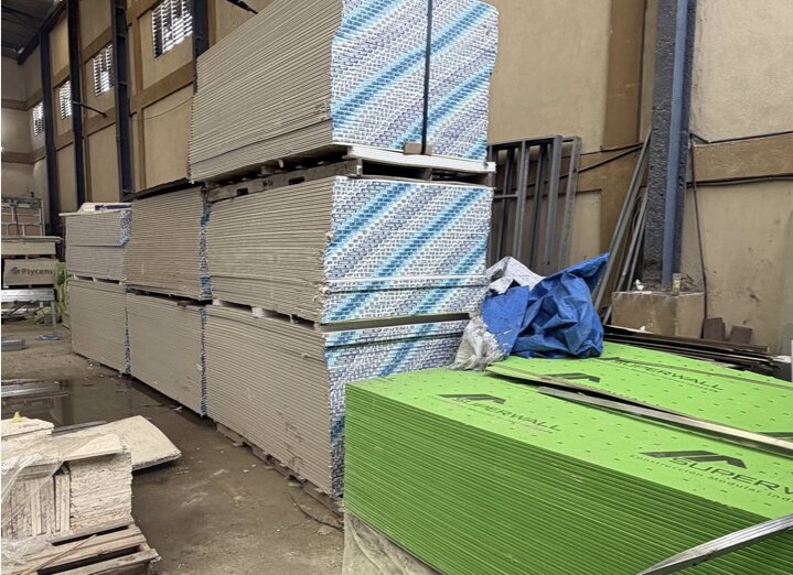Pallets of gypsum board, cement board and green exterior sheathing stacked in the plant