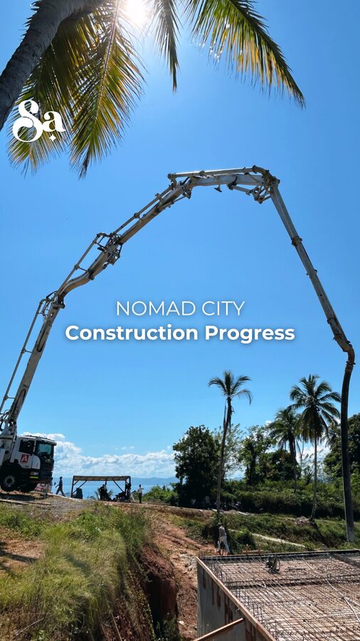 Nomad City construction progress cover showing a concrete pump on site