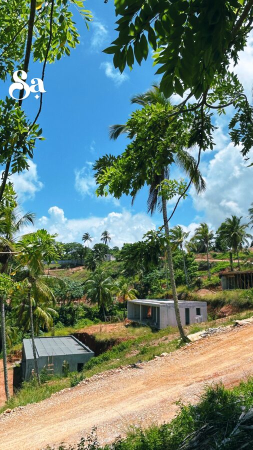 A new road cut through Nomad City with houses under construction beyond